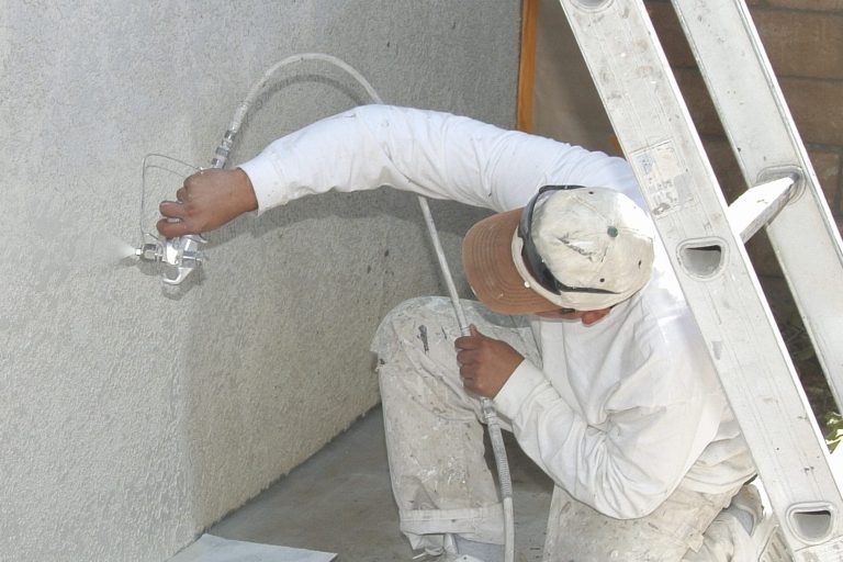 handyman painting a room white